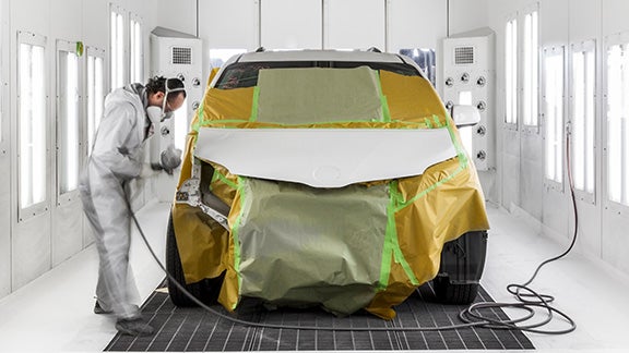 Collision Center Technician Painting a Vehicle | Gresham Toyota in Gresham OR